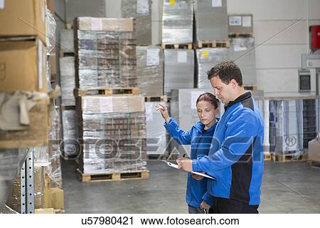 Factory workers checking pallets View Large Photo Image Stock Image - Factory workers checking pallets. Fotosearch