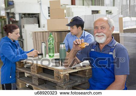 Factory workers taking break View Large Photo Image Stock Image - Factory workers taking break. Fotosearch