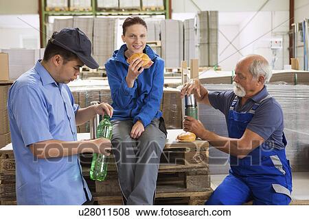 Factory workers taking break View Large Photo Image Stock Photo - Factory workers taking break. Fotosearch