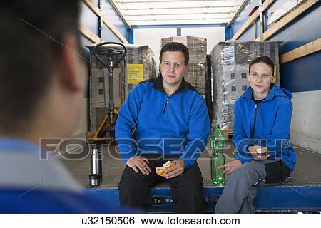 Stock Photograph - Factory workers taking break. Fotosearch