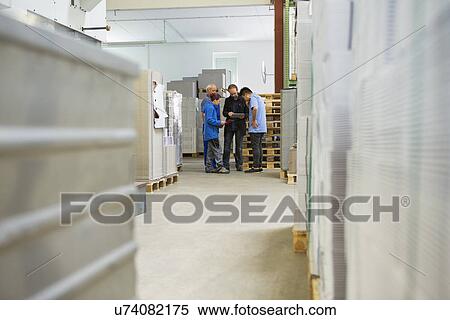 Stock Photography - Factory workers with supervisor. Fotosearch