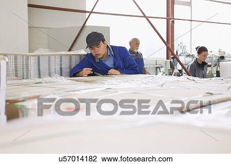 Factory workers working with cardboard View Large Photo Image Stock Image - Factory workers working with cardboard. Fotosearch
