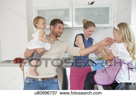Stock Photo - Family baking in kitchen. Fotosearch
