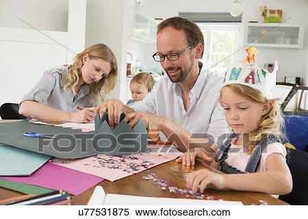 Family making paper crowns View Large Photo Image Stock Photography - Family making paper crowns. Fotosearch