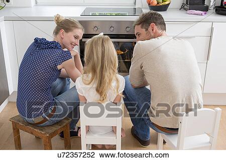 Family watching oven View Large Photo Image Stock Image - Family watching oven. Fotosearch