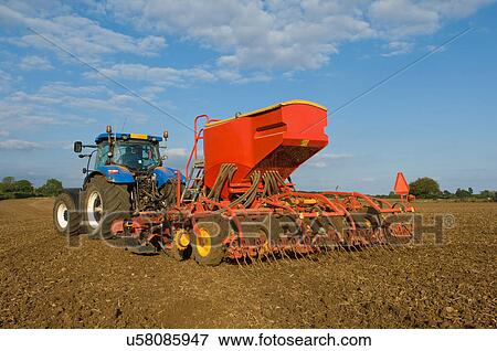 Farmer driving tractor and drilling seed corn in field View Large Photo Image Stock Photo - Farmer driving tractor and drilling seed corn in field. Fotosearch