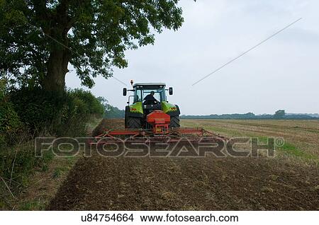 Farmer driving tractor and planting seed corn in field View Large Photo Image Picture - Farmer driving tractor and planting seed corn in field. Fotosearch