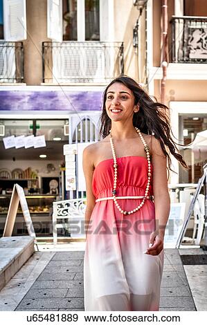 Fashionable young woman strolling down street, Cagliari, Sardinia, Italy View Large Photo Image Stock Photo - Fashionable young woman strolling down street, Cagliari, Sardinia, Italy. Fotosearch