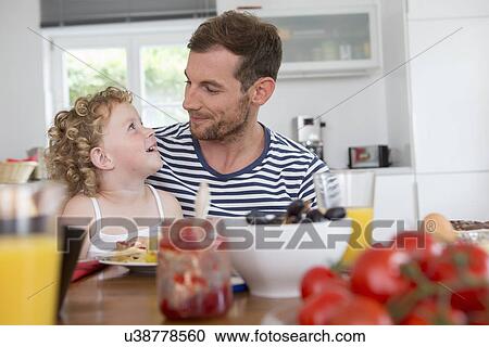 Father and daughter at kitchen table View Large Photo Image Stock Image - Father and daughter at kitchen table. Fotosearch