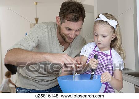 Father and daughter baking View Large Photo Image Stock Photo - Father and daughter baking. Fotosearch