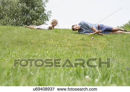 Father and daughter rolling downhill View Large Photo Image Stock Photo - Father and daughter rolling downhill. Fotosearch