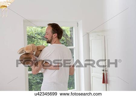 Father holding baby daughter in arms View Large Photo Image Stock Photo - Father holding baby daughter in arms. Fotosearch