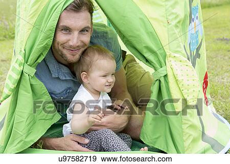 Father with baby daughter in tent View Large Photo Image Stock Photo - Father with baby daughter in tent. Fotosearch