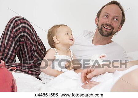 Stock Photograph - Father with baby daughter. Fotosearch
