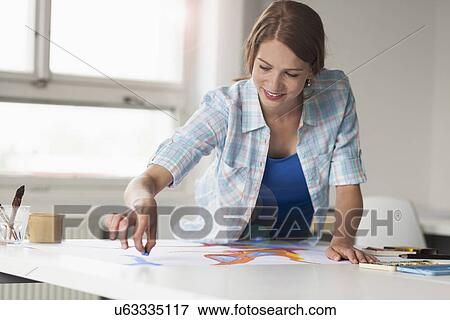 Female artist drawing View Large Photo Image Stock Photo - Female artist drawing. Fotosearch