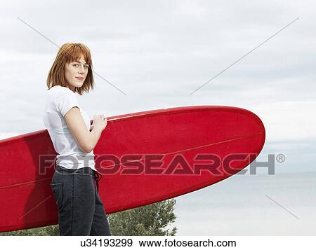Stock Photo - Female surfer with longboard surfboard, Williamstown beach, Melbourne, Australia. Fotosearch