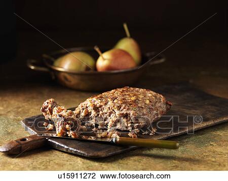 Stock Image - Festive Christmas ingredients of pork, pear and walnut stuffing with pears. Fotosearch