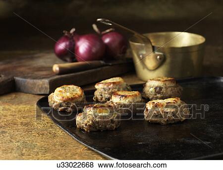 Stock Photo - Festive Christmas ingredients of pork & wild mushroom stuffing with red onions. Fotosearch