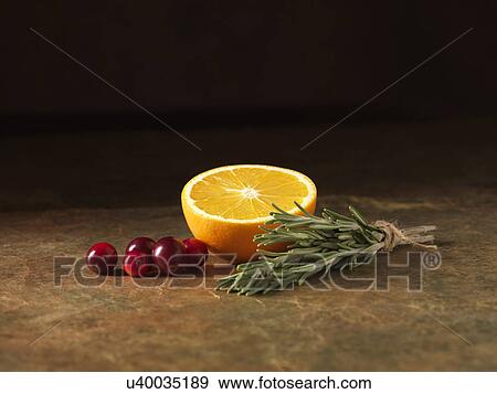 Festive Christmas ingredients of orange, cranberry and rosemary for stuffing balls with port cranberry sauce centres View Large Photo Image Stock Photo - Festive Christmas ingredients of orange, cranberry and rosemary for stuffing balls with port cranberry sauce centres. Fotosearch