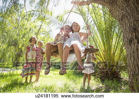 Five girls playing with tree swing in garden View Large Photo Image Stock Photography - Five girls playing with tree swing in garden. Fotosearch