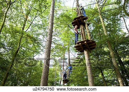 Stock Image - Friends having a fun day out in the woods. Fotosearch