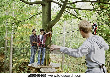 Stock Photography - Friends having a fun day out in the woods. Fotosearch