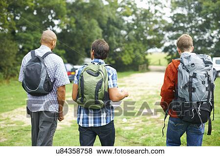 Friends walking in fields View Large Photo Image Stock Photo - Friends walking in fields. Fotosearch