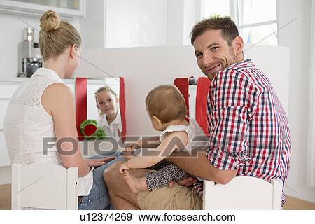 Stock Photo - Girl doing puppet show for family. Fotosearch
