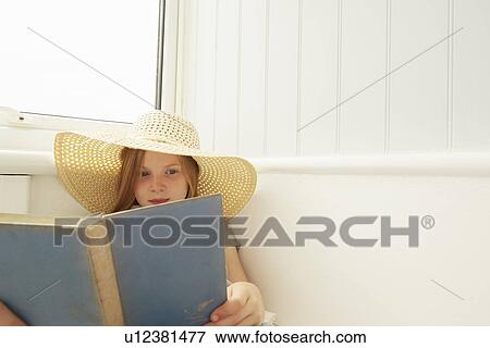 Girl in sunhat reading in holiday apartment porch View Large Photo Image Stock Photo - Girl in sunhat reading in holiday apartment porch. Fotosearch