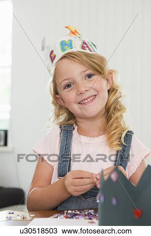 Girl making paper crown View Large Photo Image Stock Image - Girl making paper crown. Fotosearch