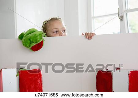 Girl peering over toy theatre with puppet View Large Photo Image Stock Photography - Girl peering over toy theatre with puppet. Fotosearch