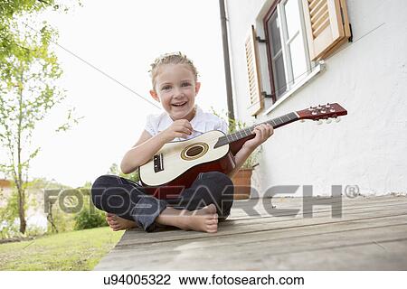 Girl playing guitar View Large Photo Image Stock Image - Girl playing guitar. Fotosearch