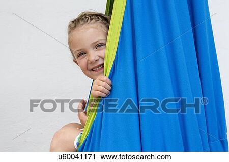 Girl playing in blue hammock View Large Photo Image Stock Image - Girl playing in blue hammock. Fotosearch