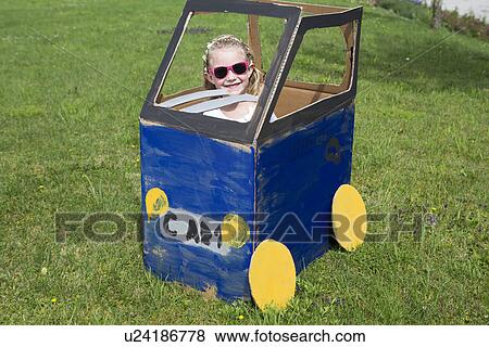 Girl playing in homemade toy car View Large Photo Image Stock Photo - Girl playing in homemade toy car. Fotosearch
