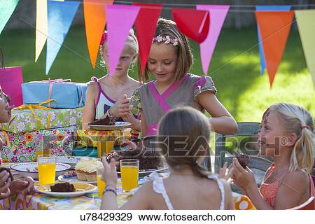 Girl serving friends birthday cake View Large Photo Image Stock Photo - Girl serving friends birthday cake. Fotosearch