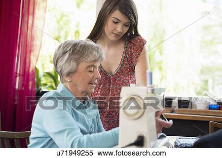 Granddaughter watching grandmother use sewing machine View Large Photo Image Stock Photography - Granddaughter watching grandmother use sewing machine. Fotosearch