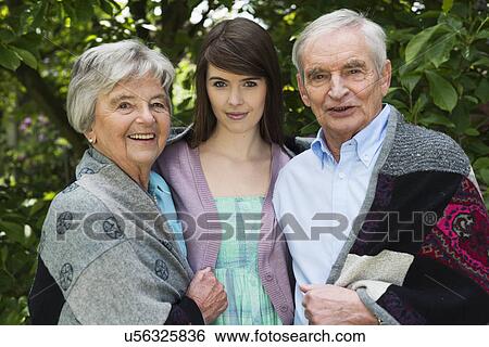 Grandparents and granddaughter in garden View Large Photo Image Stock Photograph - Grandparents and granddaughter in garden. Fotosearch
