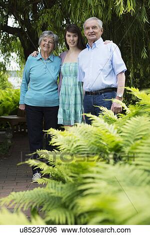 Grandparents and granddaughter in garden View Large Photo Image Stock Photograph - Grandparents and granddaughter in garden. Fotosearch