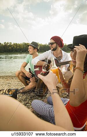 Group of friends drinking beer View Large Photo Image Stock Photo - Group of friends drinking beer. Fotosearch