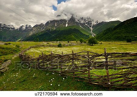 Picture - Hand woven fence and distant mountains, Mazeri village, Svaneti, Georgia. Fotosearch