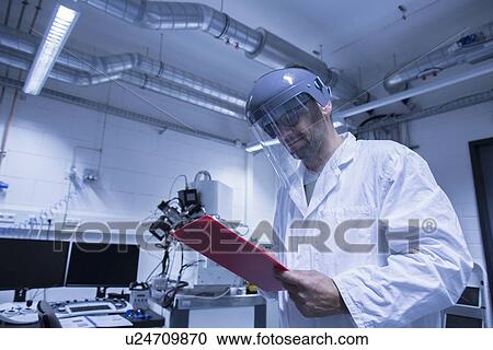 Lab assistant checking details on clipboard View Large Photo Image Stock Image - Lab assistant checking details on clipboard. Fotosearch