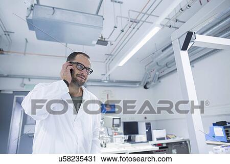 Lab assistant using smartphone View Large Photo Image Stock Image - Lab assistant using smartphone. Fotosearch