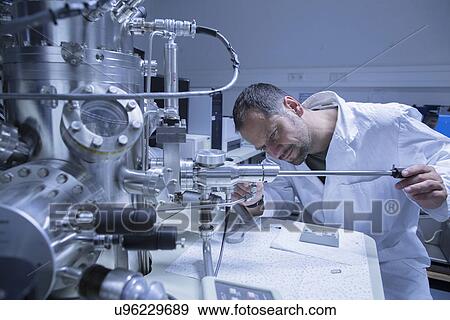 Lab assistant working on equipment View Large Photo Image Stock Photo - Lab assistant working on equipment. Fotosearch