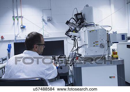 Lab assistant working with scanning electron microscope View Large Photo Image Picture - Lab assistant working with scanning electron microscope. Fotosearch