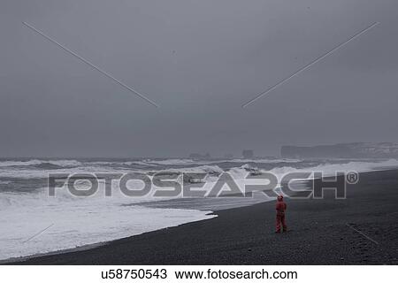 Man on beach, Vik, Iceland View Large Photo Image Stock Image - Man on beach, Vik, Iceland. Fotosearch