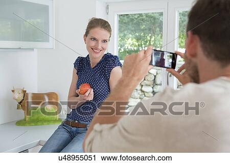 Man photographing woman with camera phone View Large Photo Image Stock Image - Man photographing woman with camera phone. Fotosearch