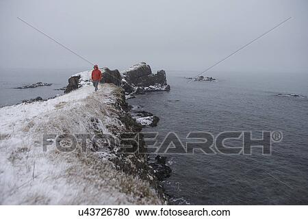 Man standing on edge of islet, Iceland View Large Photo Image Stock Image - Man standing on edge of islet, Iceland. Fotosearch