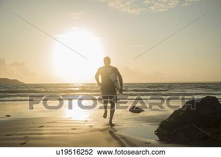 Mature man, running towards sea, holding surf board View Large Photo Image Stock Image - Mature man, running towards sea, holding surf board. Fotosearch