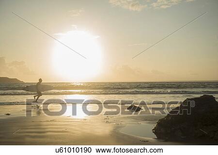 Mature man, running towards sea, holding surf board View Large Photo Image Stock Image - Mature man, running towards sea, holding surf board. Fotosearch