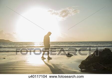Mature man, walking on beach, along coastline View Large Photo Image Picture - Mature man, walking on beach, along coastline. Fotosearch